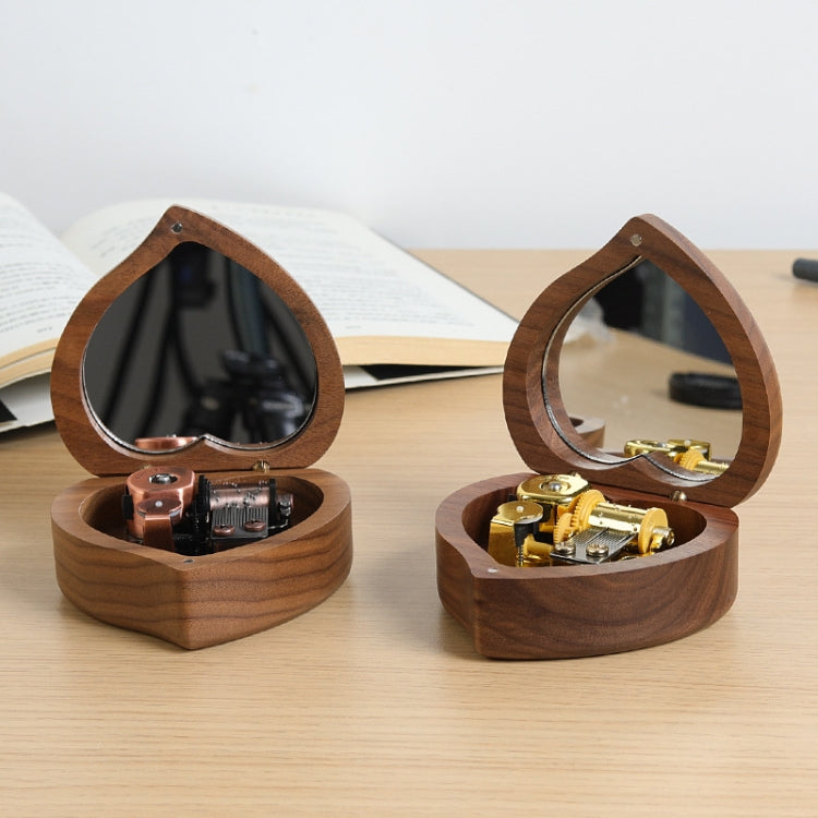 Two heart-shaped wooden music boxes with mirrored lids and visible gold-tone mechanisms