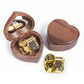 Dark heart-shaped wooden music box with mirror lid, gold-tone mechanism, open and closed