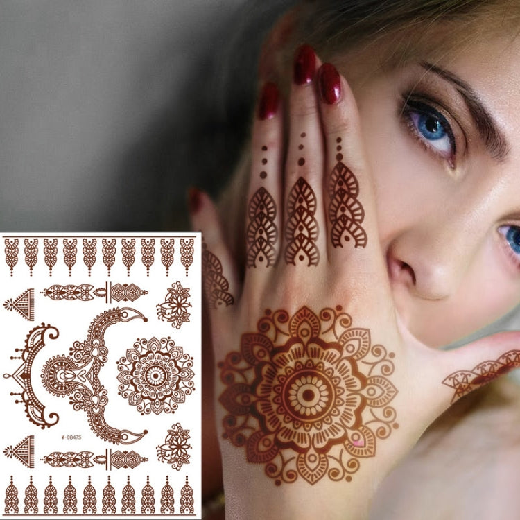 Brown-red lace henna tattoo sticker on forearm with mandala, dots, and floral linework