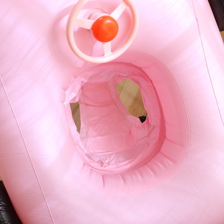 Pink inflatable pool float interior with seat opening and orange steering wheel
