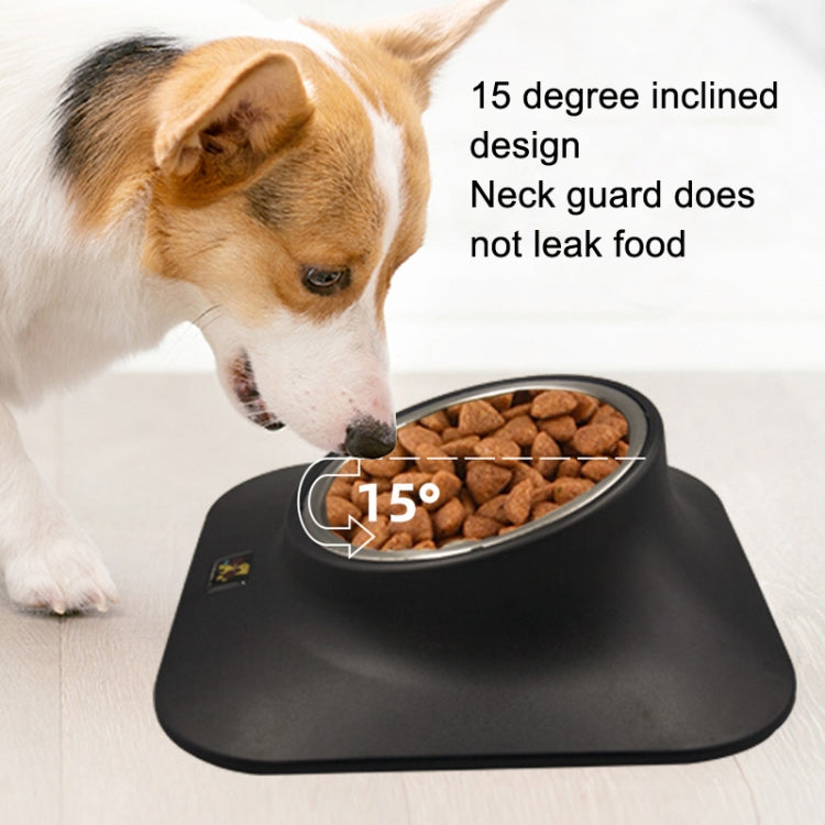 Dog eating from an inclined stainless steel pet feeder with neck guard