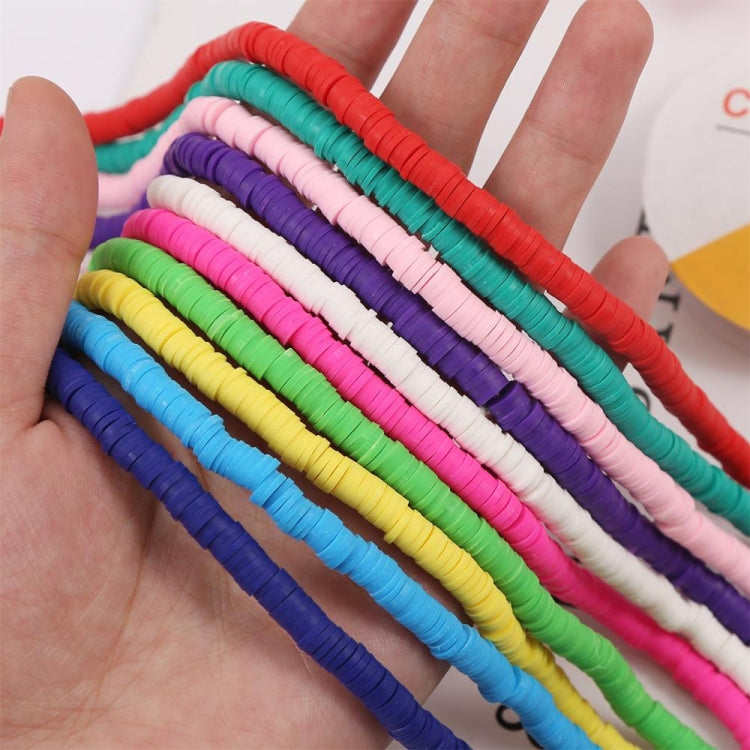 Hand holding colorful soft bead strands for DIY bracelet and necklace making