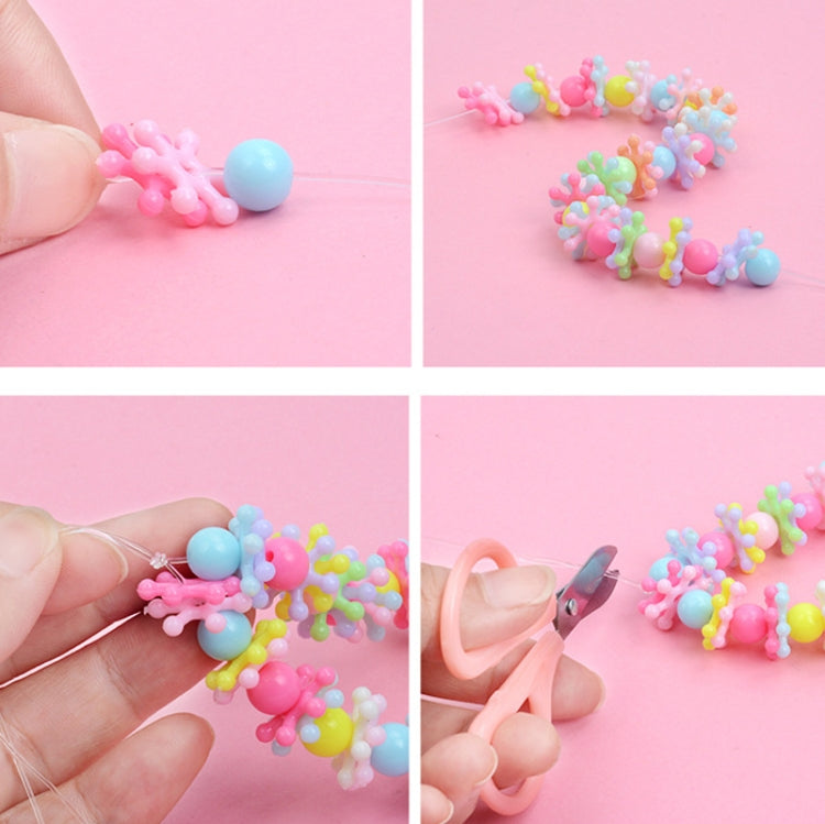 Kids making beaded bracelets with round pastel beads on string