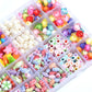 Assorted colorful plastic beads, pearl beads, and letter beads in compartment tray