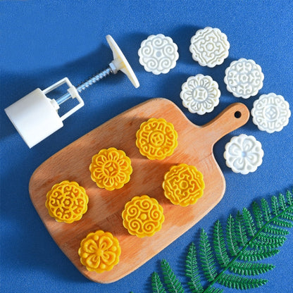 Round pastry mold set with wooden board, yellow stamped pastries, and white press tool