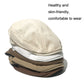 Stack of linen beret-style caps in cream, white, and brown colors