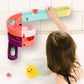Bath slide building block toy on wall with child hand and duck figure