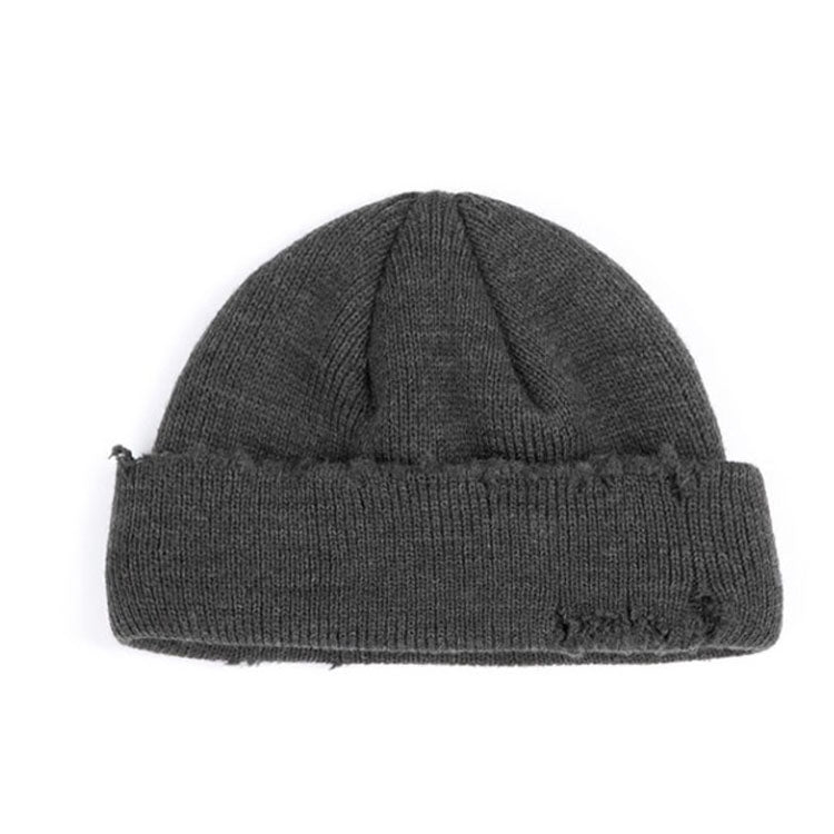 Grey ribbed knit beanie hat with cuff and small distressed frayed spots