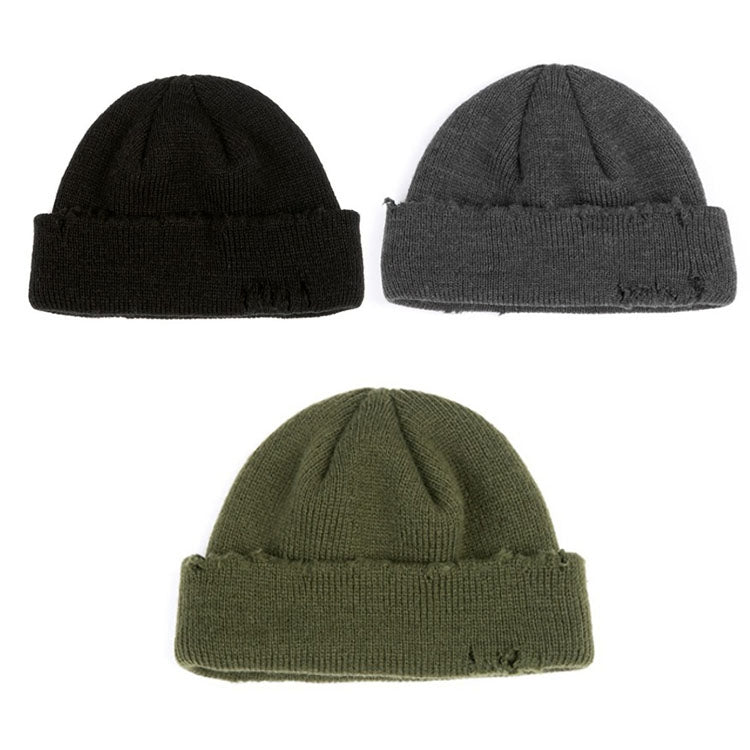 Ribbed knit beanie hat in black, grey, and green with distressed frayed spots