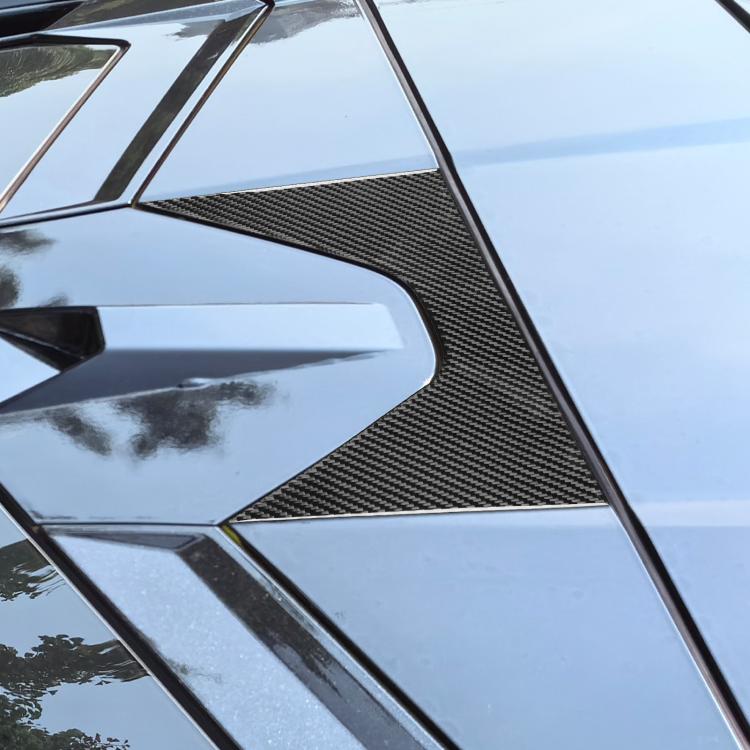 Close-up of black carbon-fiber weave roof decoration sticker on car panel