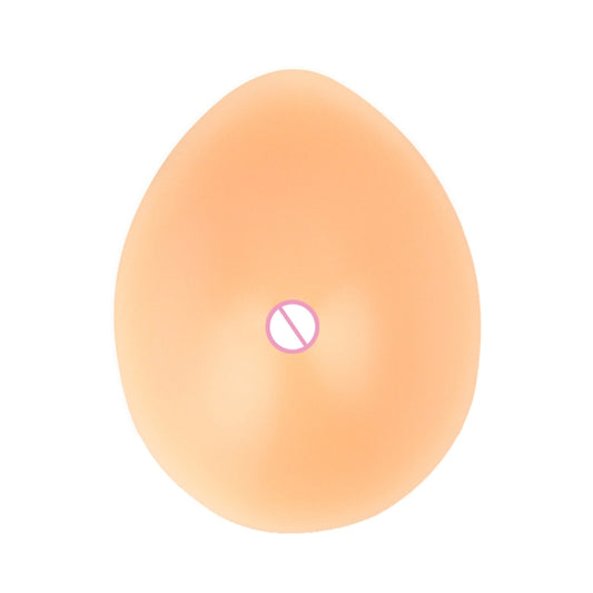 Silicone breast prosthesis with drop shape, flesh tone, smooth finish and nipple detail.