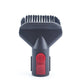 Small vacuum brush head with dark bristles and red control button.
