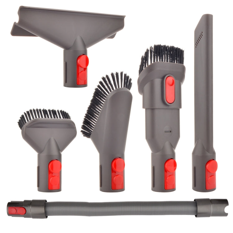 Vacuum cleaner accessory set with grey brush heads, hose, and red lever clips
