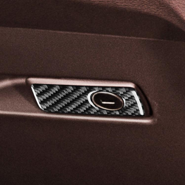 Installed glove box handle sticker with carbon-fiber pattern and round silver-rim insert