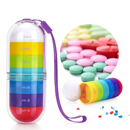 Cylindrical 7-compartment rotary plastic pill box with purple carry loop, clear shell