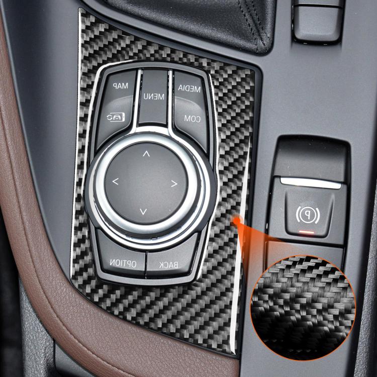 Installed carbon-fiber knob panel sticker around multimedia control in BMW interior