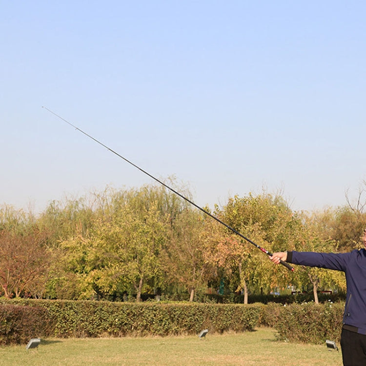 Telescopic mini fishing rod extended outdoors for casting a fishing line