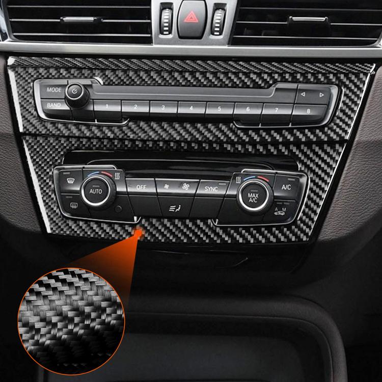 Installed carbon-fiber center console trim over radio and climate controls, close-up