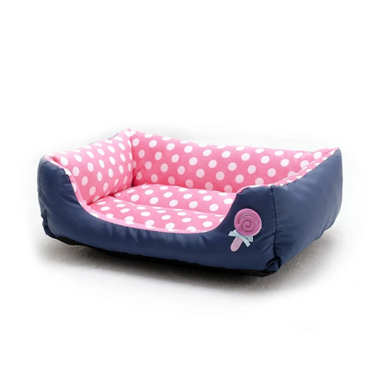 Square pet bed with pink polka dots, navy sides, and lollipop patch