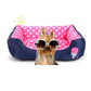 Square pet kennel cushion with pink polka-dot inner, dark blue outer, and rose applique