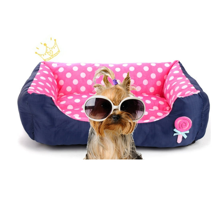 Square pet kennel cushion with pink polka-dot inner, dark blue outer, and rose applique