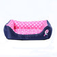 Pink polka dot pet kennel cushion with navy sides and a square bolstered bed