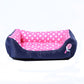 Square pet kennel cushion with pink polka dot center and dark side bolsters