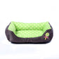 Square pet kennel cushion with green polka-dot inner, dark outer, and rose applique