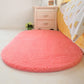 Pink oval plush pet bed pad with soft shag surface