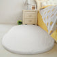 White oval plush pet bed pad with soft fluffy surface