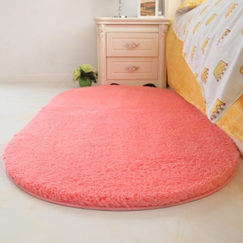 Pink oval plush pet bed pad with soft shag pile and flat surface