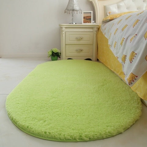 Green oval plush pet bed pad with soft shag pile and flat surface