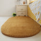 Khaki tan oval plush pet bed pad with soft shag pile and flat surface