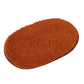 Brown plush pet bed pad with shag texture and rounded oval shape