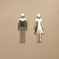 Restroom wall signs in chrome with female and male pictograms, mounted on wall