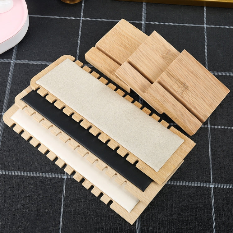 Stacked bamboo necklace stands with beige, cream, and black fabric panels