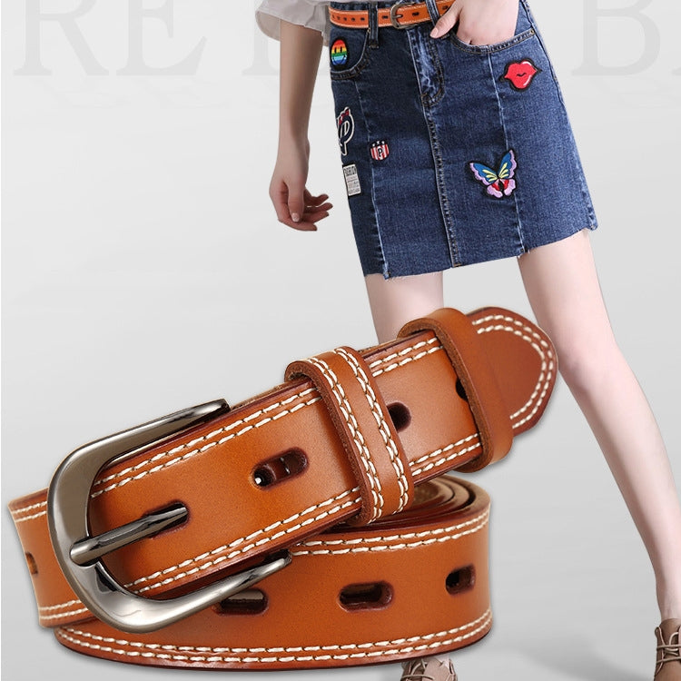 Double-stitched hollow pin buckle belt worn with denim skirt, orange-brown leather and silver buckle