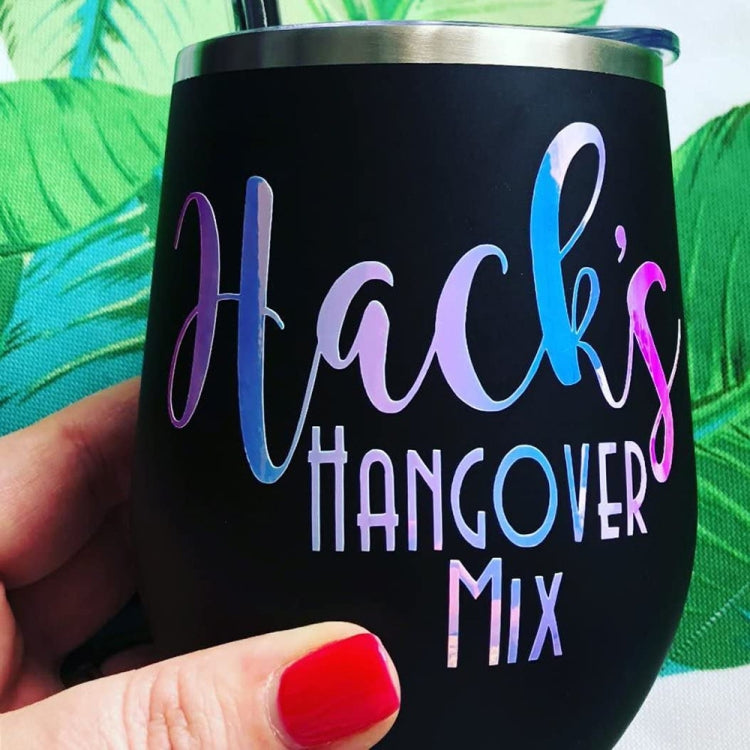 Printed vinyl decal on a black tumbler cup with multicolor cursive text