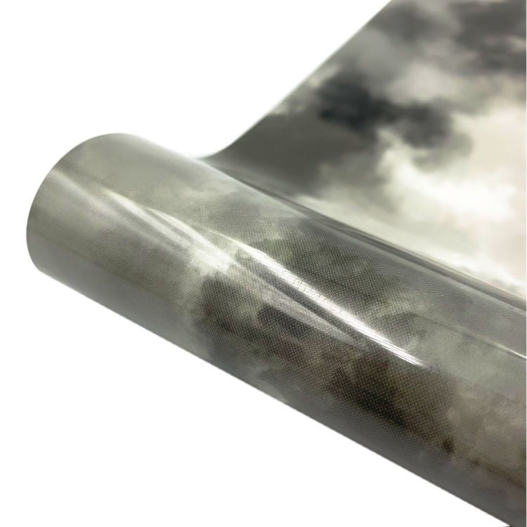 Close-up cloud watercolor tie-dye heat transfer vinyl roll, dark gray swirls on clear base