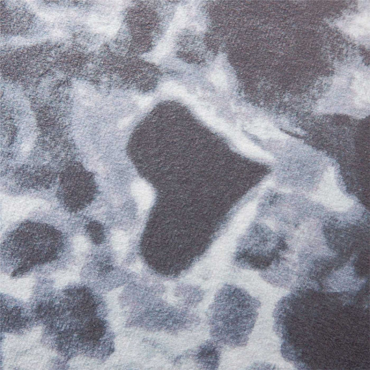 Close-up of gray and white speckled plush fabric on seal pillow