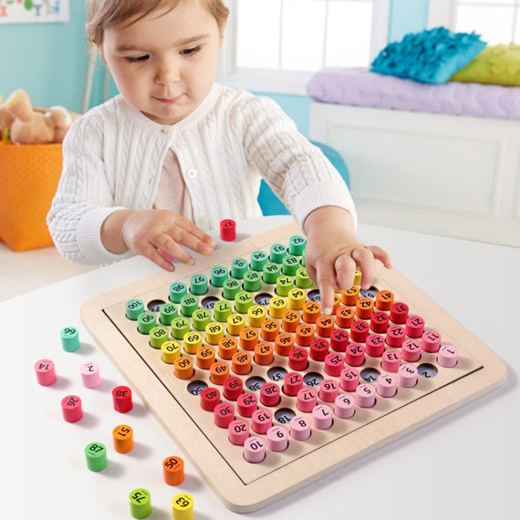 Child playing with a colorful number puzzle board and numbered peg pieces