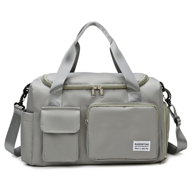 Light grey waterproof travel gym bag with front zip pocket, dual handles, and shoulder strap
