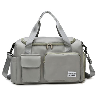 Light grey waterproof travel gym bag with front zip pocket, dual handles, and shoulder strap