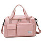 Soft pink waterproof travel gym bag with front zip pocket, dual handles, and shoulder strap