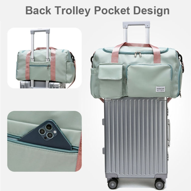 Light teal duffel bag with back trolley pocket, secured on a rolling suitcase