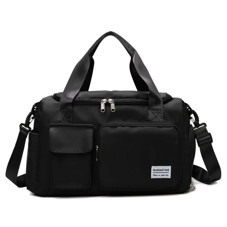 Black waterproof travel duffel bag with front pockets, top zipper, and shoulder strap