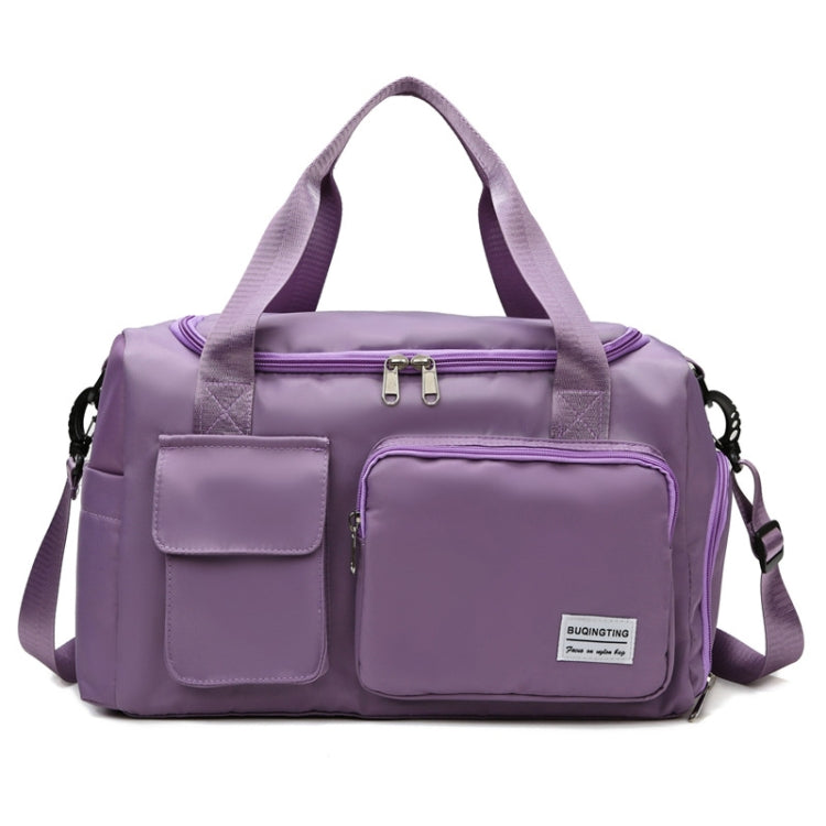 Purple waterproof travel duffel bag with front pockets, zip top, and shoulder strap