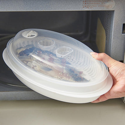 Oval microwave fish steamer plate with clear lid, white base and vent holes.