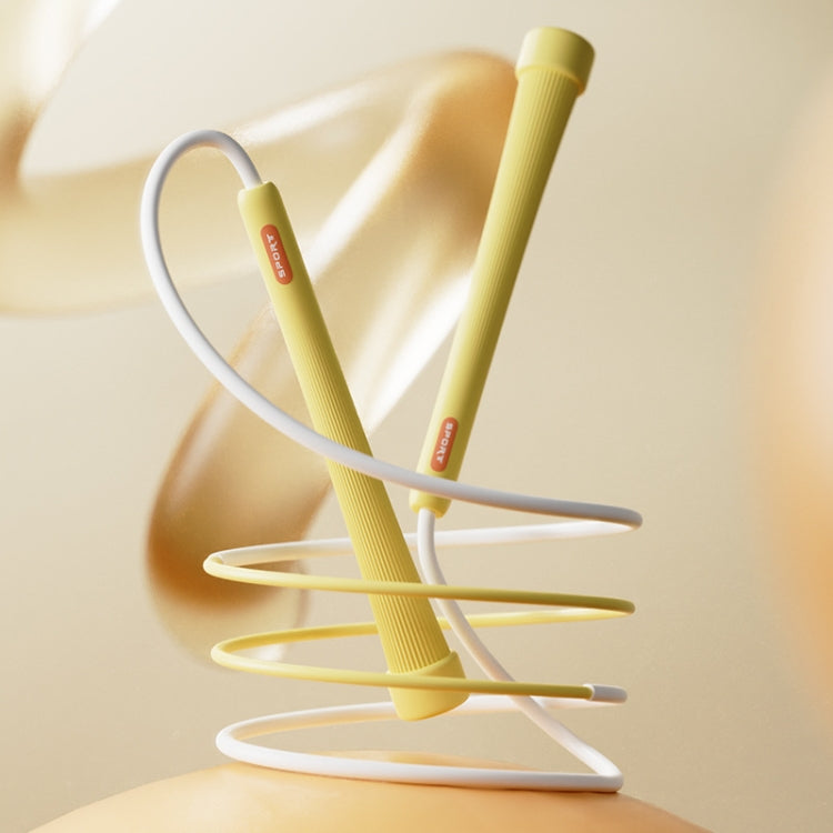 Kids skipping rope with yellow handles and white rope, coiled base.