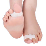 Double ring toe separators on feet, white spacer bands between toes